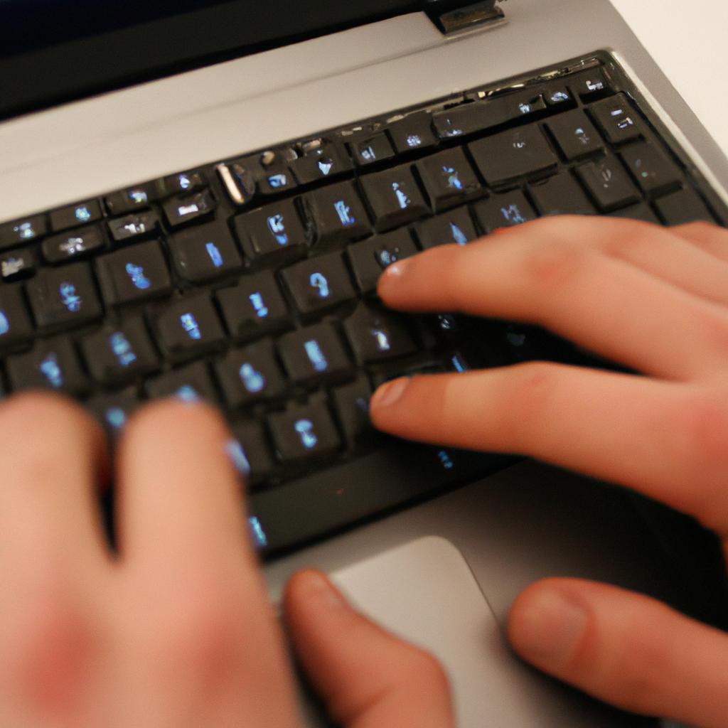 Person typing on laptop, coding