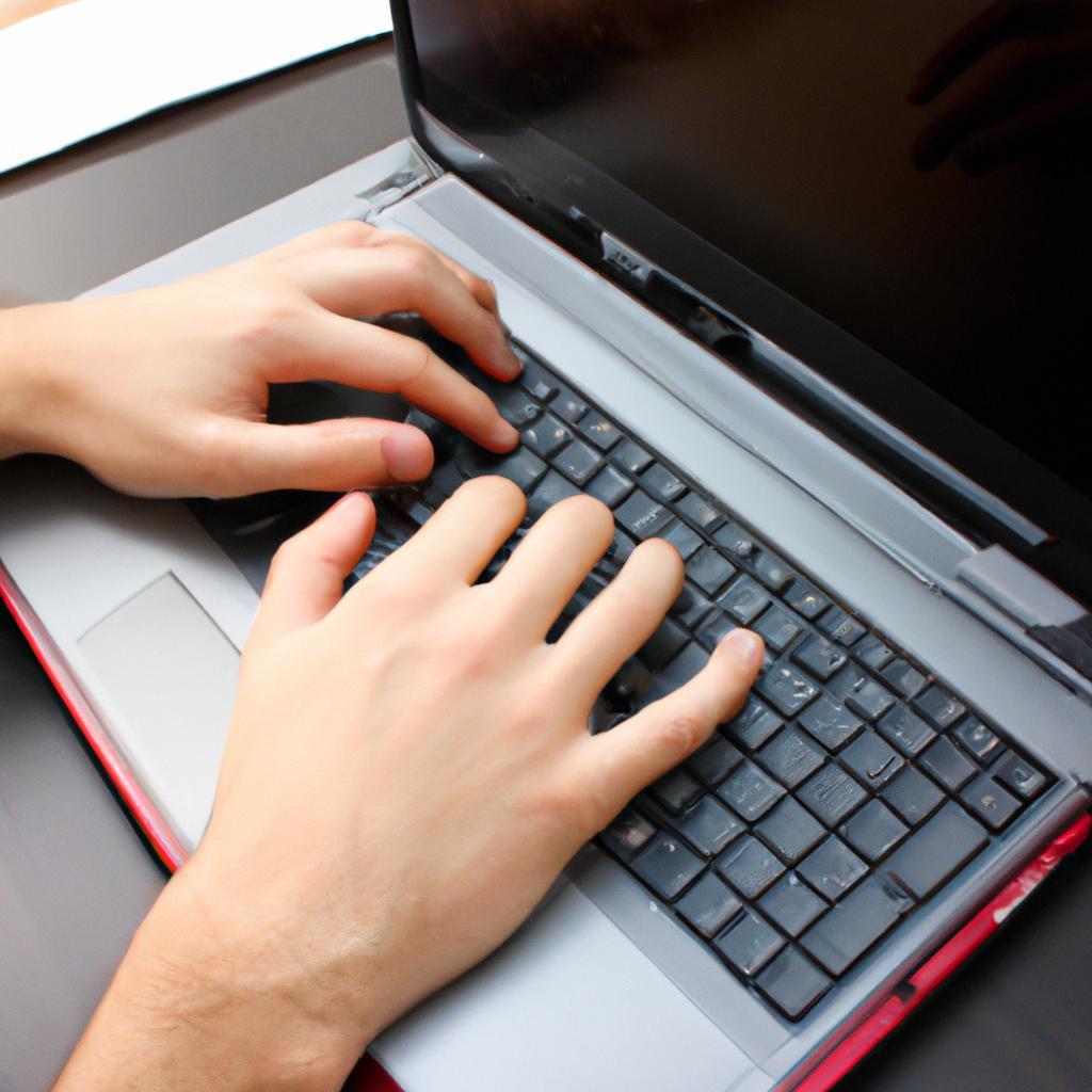 Person typing on laptop computer